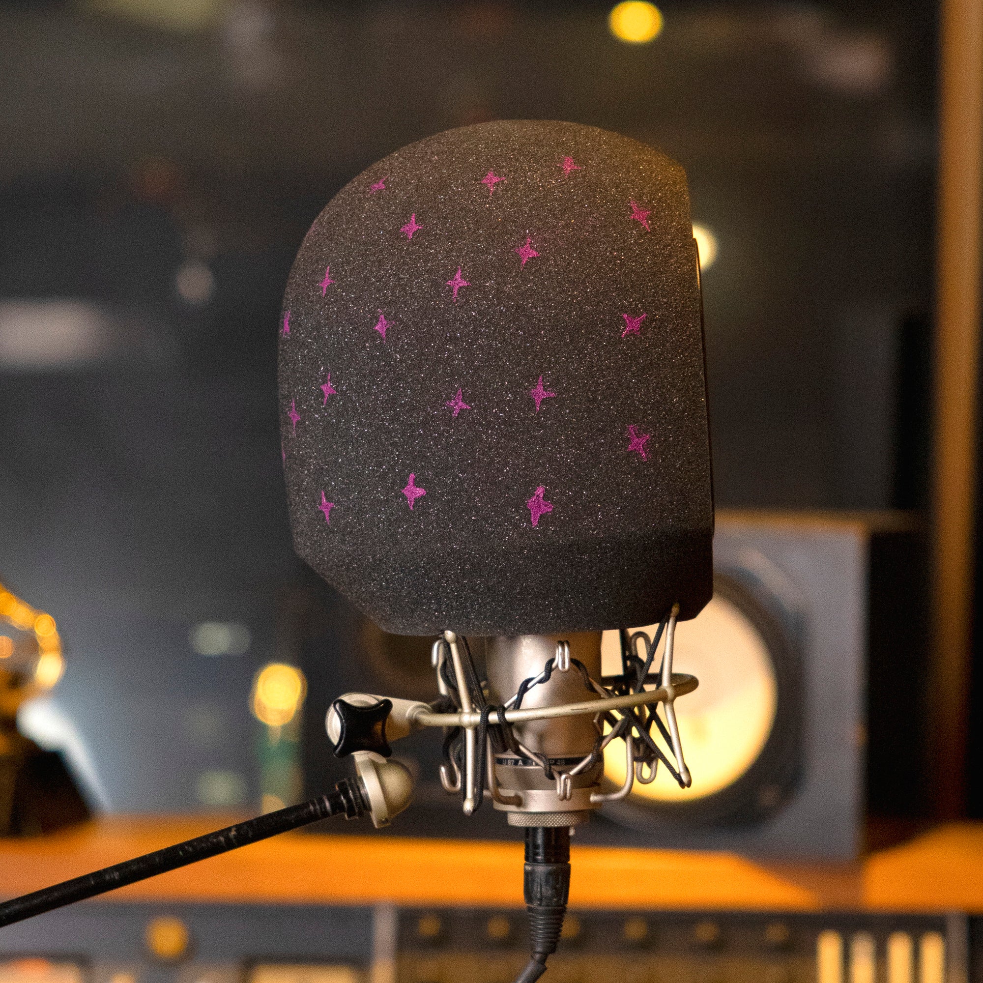 Hand painted purple stars on back of portable studio microphone isolation booth